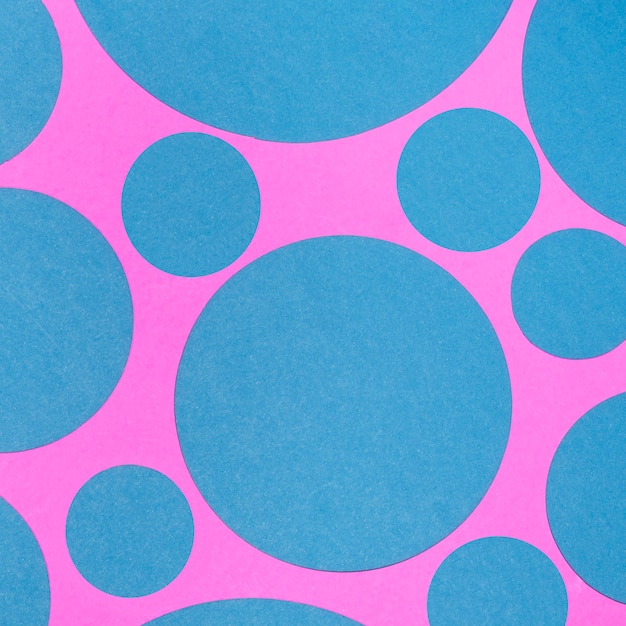 Free photo blue seamless pattern of circles on pink backdrop