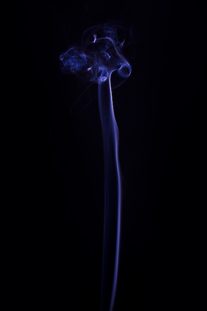 Free photo blue smoke moving upward against black background