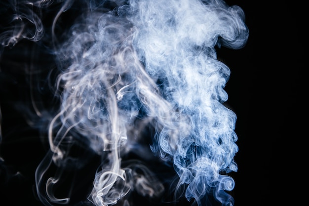 Free photo blue smoke waves on black background