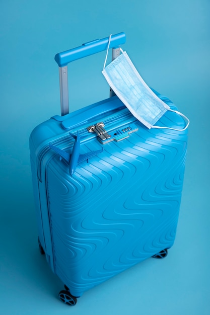 Free photo blue suitcase for travel with medical mask