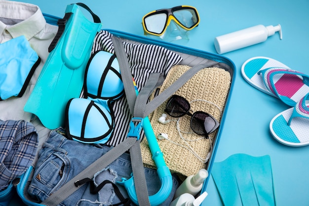 Blue suitcase with travel paraphernalia