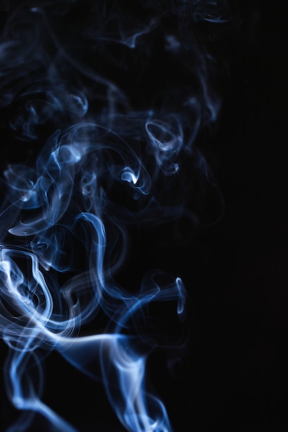 Blue wavy smoke on black background