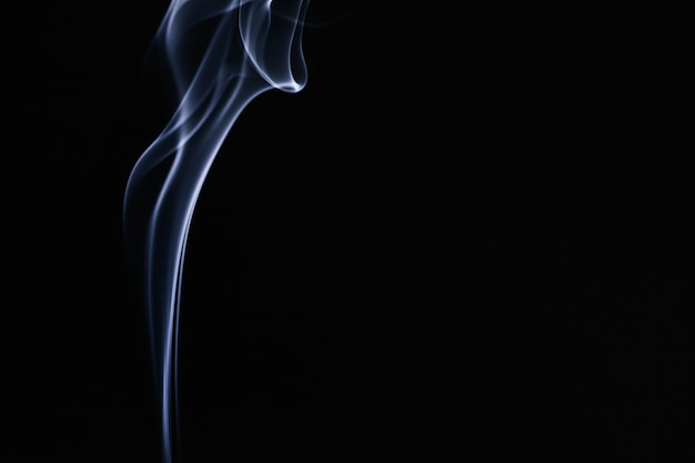 Free photo blue wavy smoke on black background