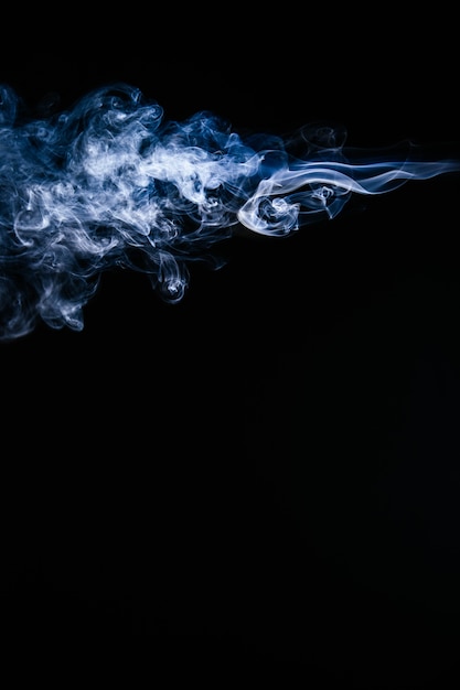 Blue wavy smoke on black background