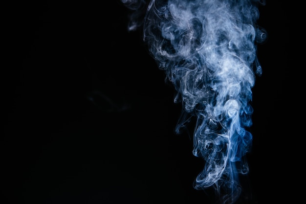 Free photo blue wavy smoke on black background