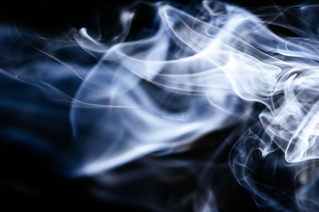 Blue wavy smoke on black background