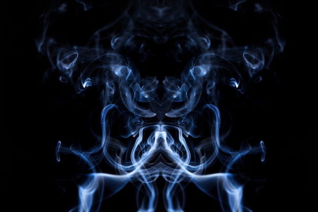 Free photo blue wavy smoke on black background