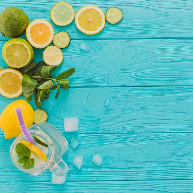 Free photo blue wooden surface with lemons and limes