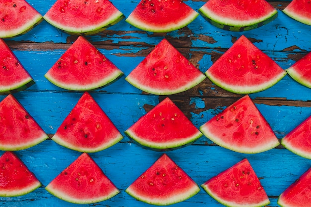 Blue wooden surface with watermelon portions