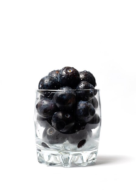 Blueberries in a glass cup isolated