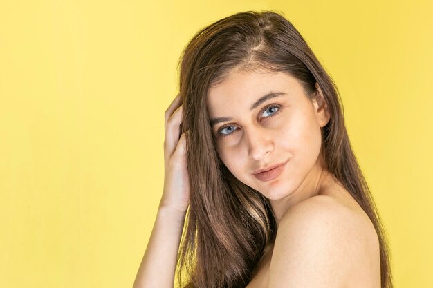 Free Photo blueeyed girl on yellow background