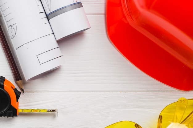 Blueprints and protective wear on table