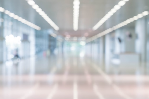 Free photo blurred abstract background interior view looking out toward to empty office lobby and entrance doors and glass curtain wall with frame