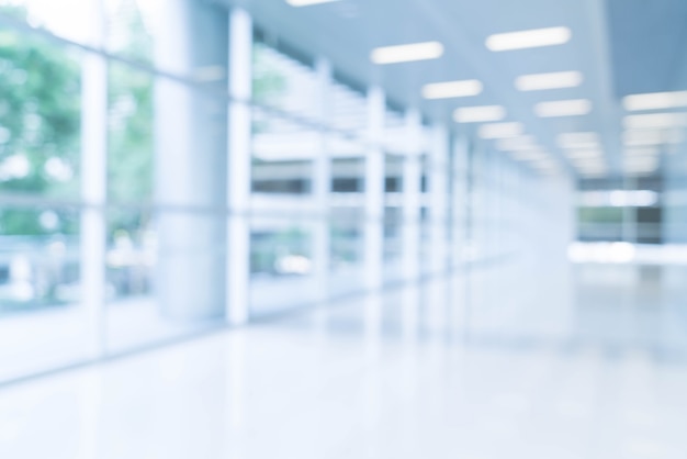 Blurred abstract background interior view looking out toward to empty office lobby and entrance doors and glass curtain wall with frame