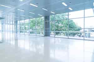 Free photo blurred abstract background interior view looking out toward to empty office lobby and entrance doors and glass curtain wall with frame