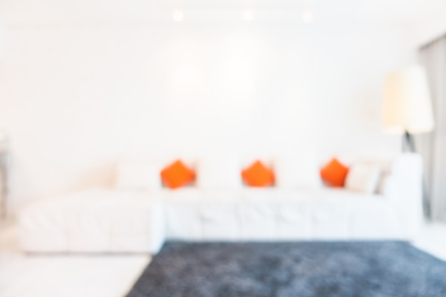 Free photo blurred couch with orange and white cushions