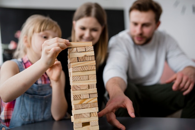 Blurred family playing jenga