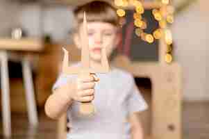 Free photo blurred kid with cardboard dagger