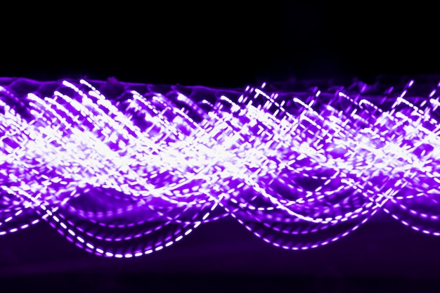 Free Photo blurred purple decorative light on black backdrop