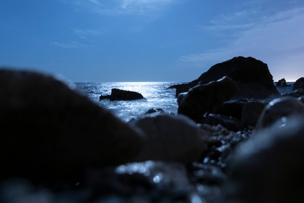 Free Photo blurred rocks in the water at night