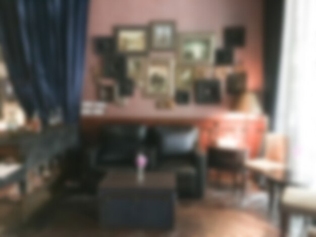 Blurred room with frames on the wall