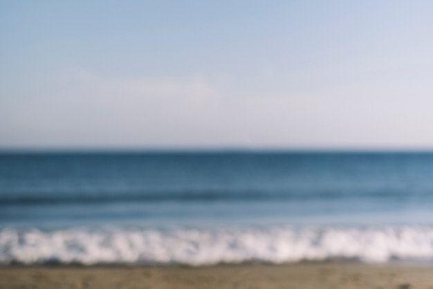 Free photo blurred view of waves at the beach