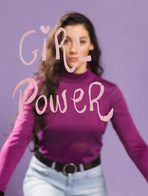 Free Photo blurred woman looking at "girl power" words on transparent glass