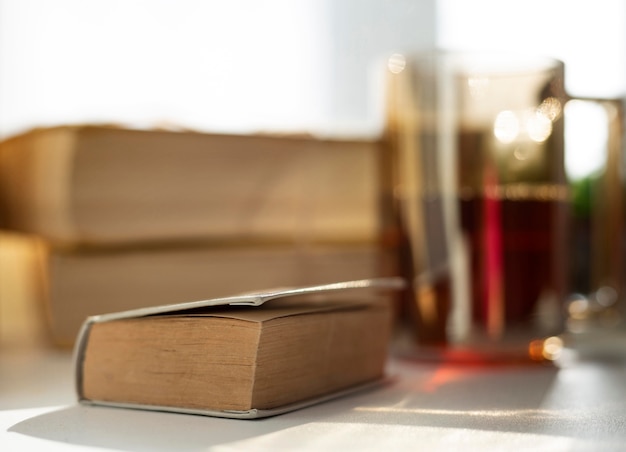 Free photo blurry arrangement with books and cup