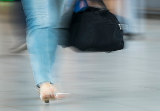 Free photo blurry shot of woman with black bag