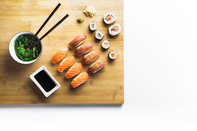 Board with sushi and seaweed salad