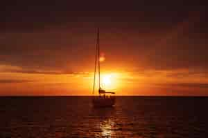 Free photo boat shipping in sea at sunset