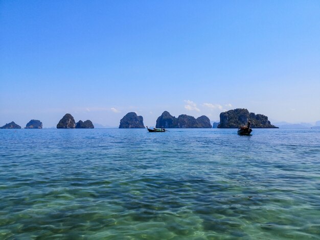 Boats in clear sea water on sunny day