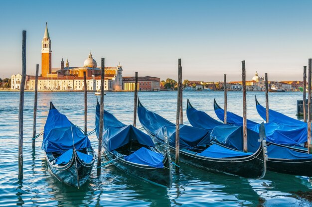 Boats parked in the water in Venice and the Church of San Giorgio Maggiore in the background