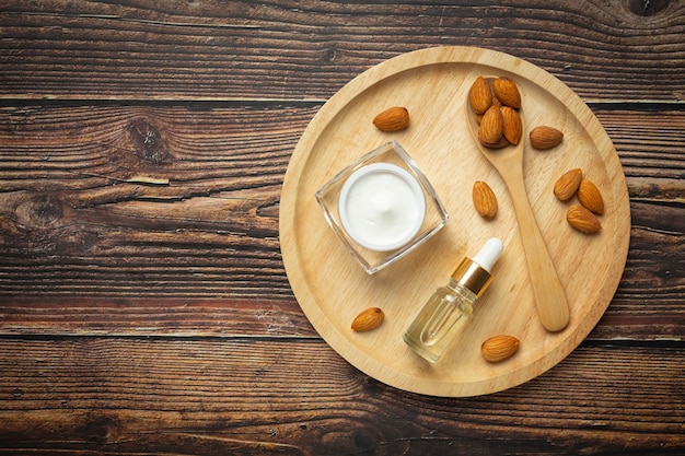 Body almond moisturizer on dark wood background