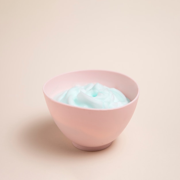 Free photo body care foam in a bowl with plain background