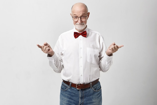 Body language. Attractive confident mature seventy year old Caucasian man wearing jeans