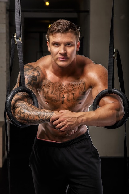 Bodybuilder posing in a gym .Studio shot