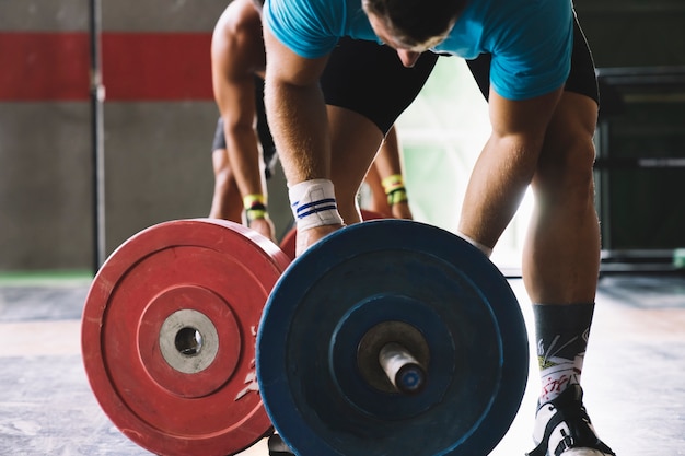 Bodybuilding concept with man and barbell