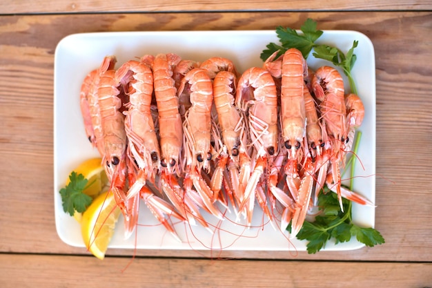 Free photo boiled crayfish, with oil and lemon sauce, on a plate, karavides in greek