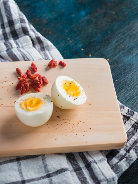 Free photo boiled egg on wooden board