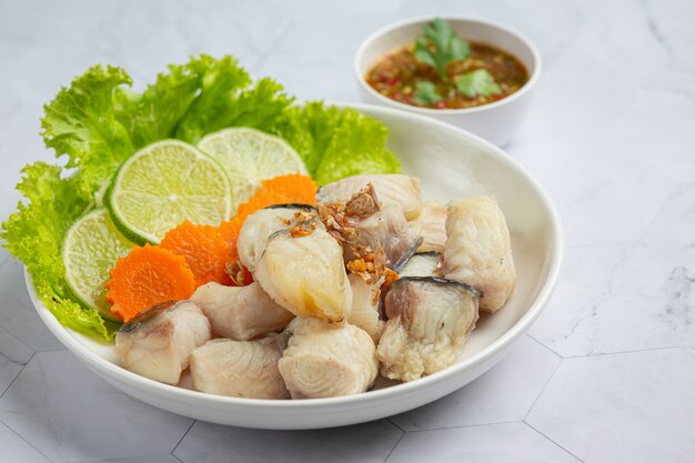 Boiled fish with spicy dipping sauce and vegetable