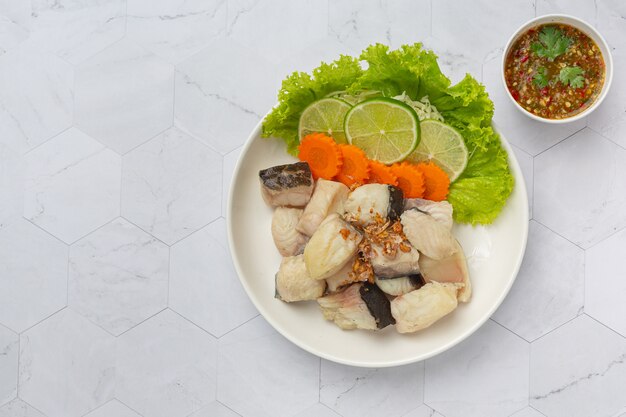 Boiled fish with spicy dipping sauce and vegetable