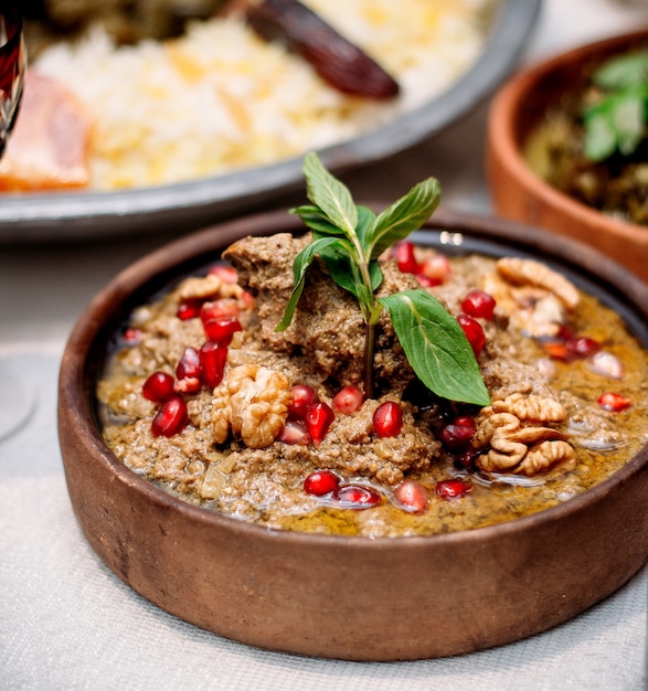 Free photo boiled meat  with pomegranate and walnuts