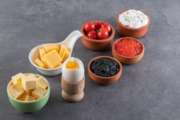 Free Photo boiled sliced eggs with spices placed on stone table . 