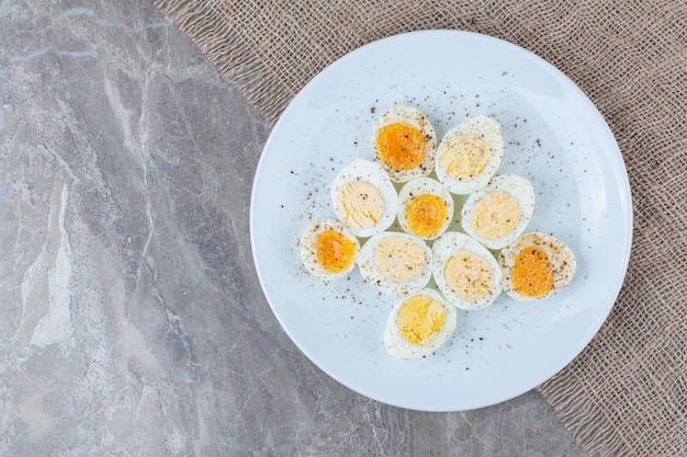 Free photo boiled tasty eggs with spices on white plate. high quality photo