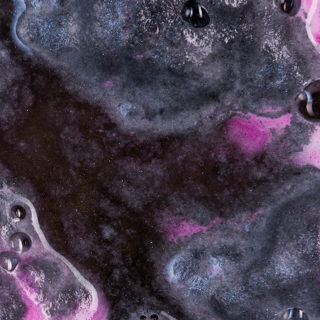 Free photo boiling black liquid with pink spume