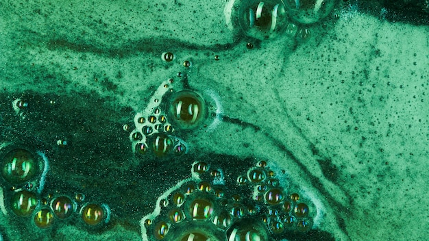 Boiling green liquid with foam and blobs