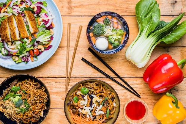 Free photo bokchoy; bell peppers and thai traditional food on table against black background