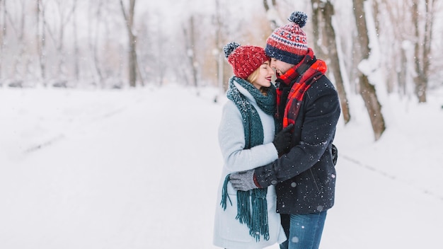 Free photo bonding young couple in winter woods