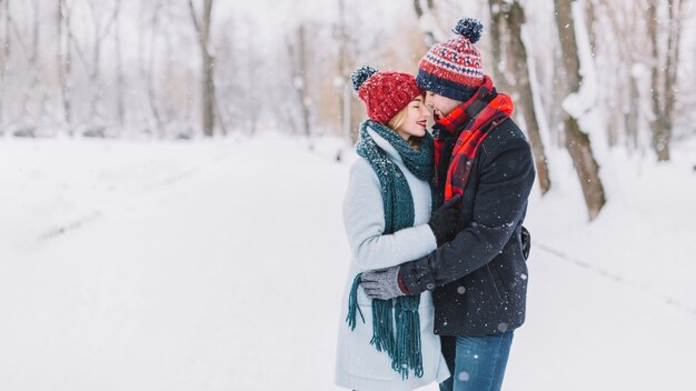 Bonding young couple in winter woods